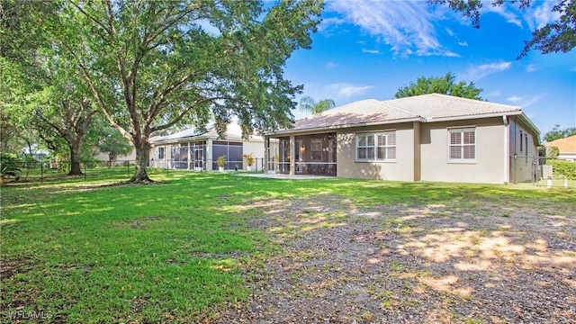 761 Grand Rapids Blvd, Naples, FL 34120 - rear view of house with a sunroom, stucco siding, and a tile roof