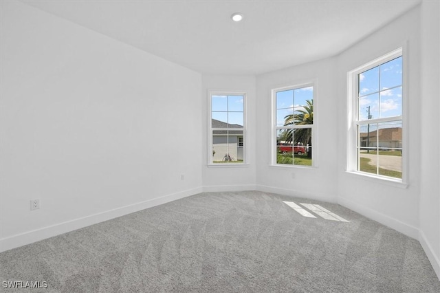 carpeted spare room with recessed lighting and baseboards