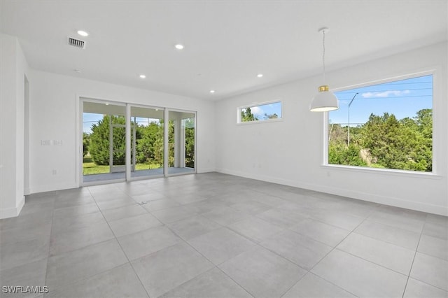 tiled empty room featuring visible vents, recessed lighting, and baseboards
