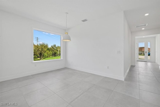 spare room featuring light tile patterned floors, visible vents, recessed lighting, and baseboards