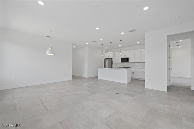unfurnished living room with baseboards and recessed lighting