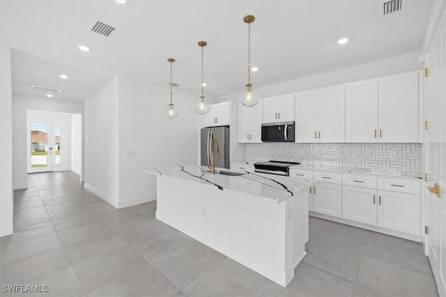 kitchen featuring tasteful backsplash, visible vents, appliances with stainless steel finishes, and white cabinets