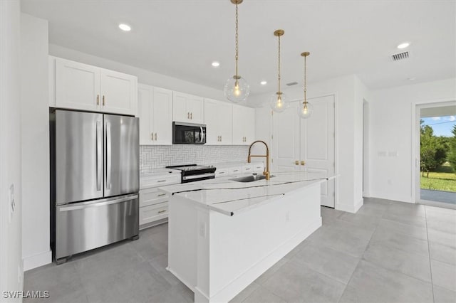 kitchen with recessed lighting, decorative backsplash, stainless steel appliances, white cabinets, and a sink