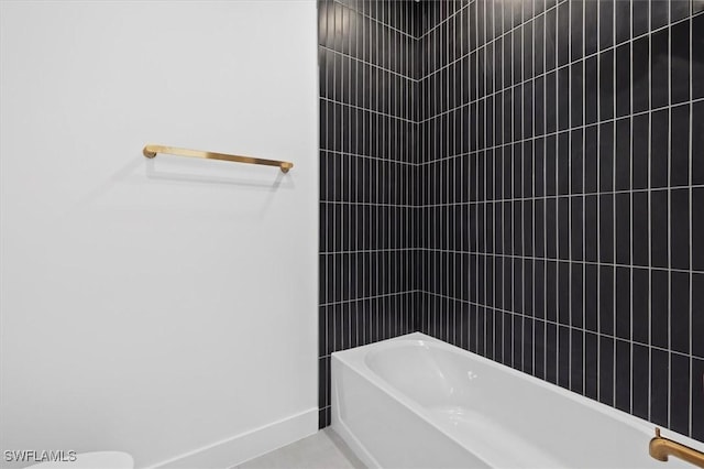 full bathroom featuring shower / washtub combination and baseboards