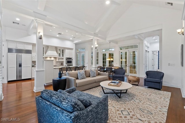 living room with high vaulted ceiling, french doors, wood finished floors, ornate columns, and visible vents