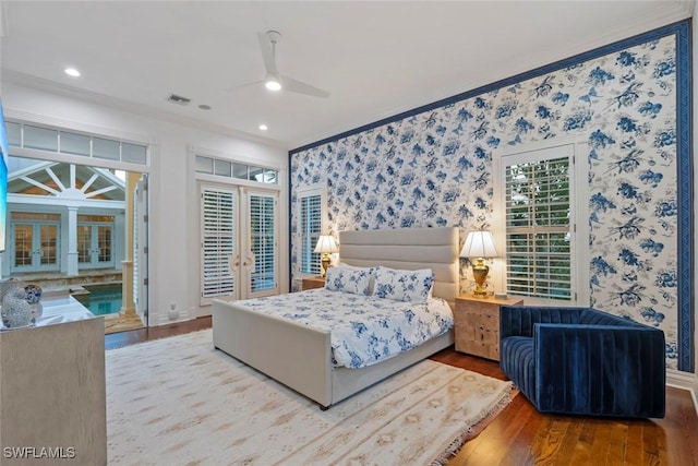 bedroom featuring french doors, wood finished floors, access to outside, and wallpapered walls