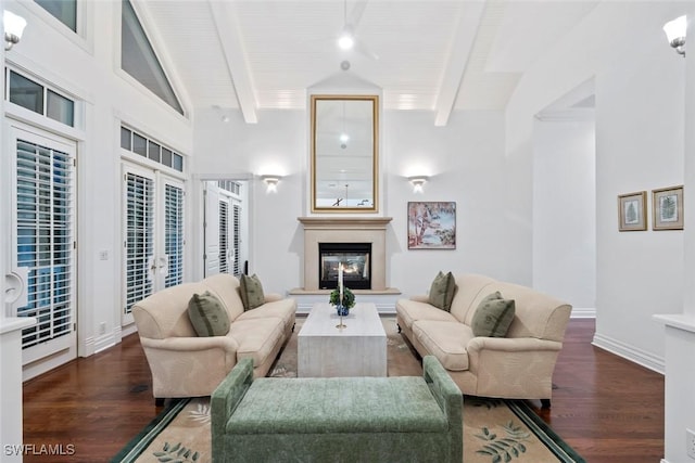 living room featuring french doors, baseboards, a glass covered fireplace, and wood finished floors