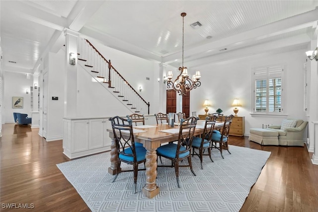 dining room with stairs, a chandelier, visible vents, and dark wood-type flooring