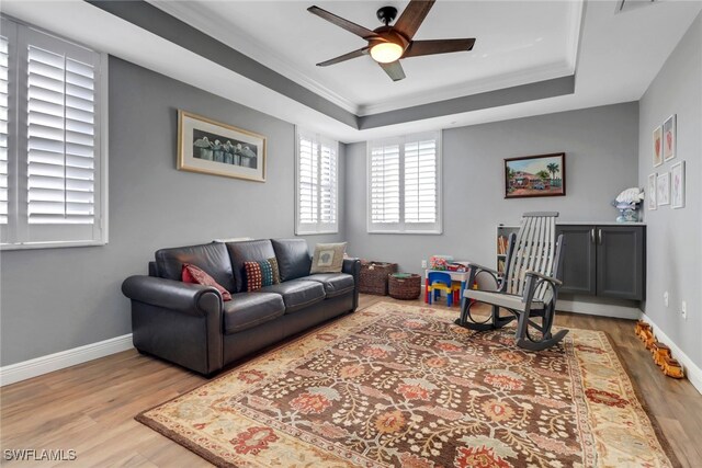 15140 Harbour Isle Dr Unit 502, Fort Myers, FL 33908 - living area with wood finished floors, crown molding, ceiling fan, a raised ceiling, and baseboards