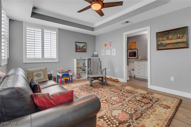 15140 Harbour Isle Dr Unit 502, Fort Myers, FL 33908 - sitting room with a tray ceiling, wood finished floors, a ceiling fan, ornamental molding, and baseboards