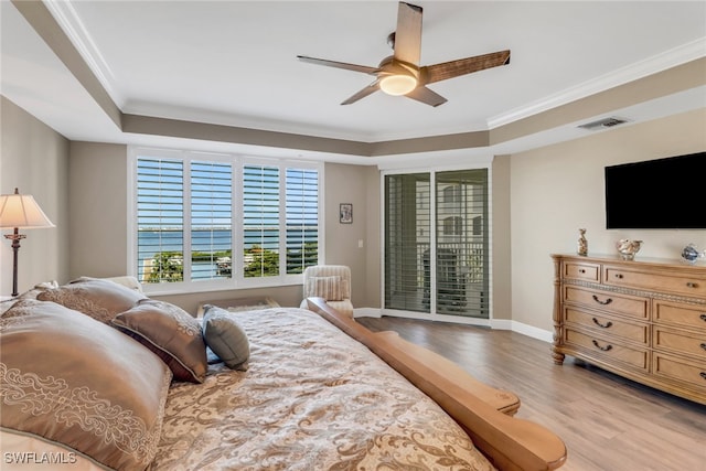 15140 Harbour Isle Dr Unit 502, Fort Myers, FL 33908 - bedroom with access to exterior, light wood-style floors, a tray ceiling, ornamental molding, and ceiling fan