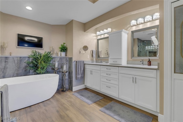 15140 Harbour Isle Dr Unit 502, Fort Myers, FL 33908 - bathroom with a freestanding bath, wood finished floors, and double vanity
