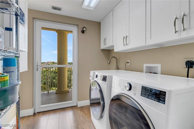 15140 Harbour Isle Dr Unit 502, Fort Myers, FL 33908 - laundry room with cabinet space, plenty of natural light, washing machine and dryer, and baseboards