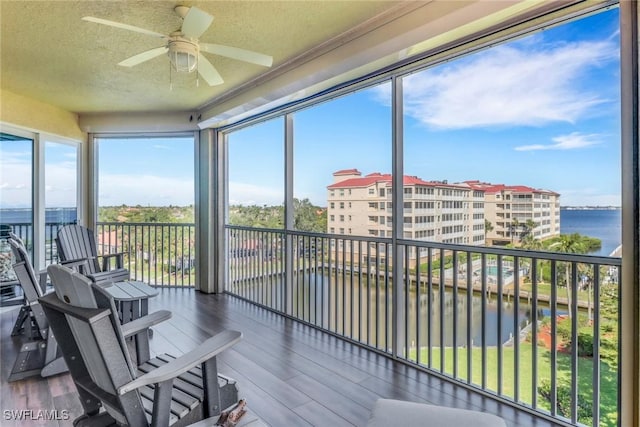 15140 Harbour Isle Dr Unit 502, Fort Myers, FL 33908 - sunroom / solarium with a water view, wood finished floors, and a textured ceiling