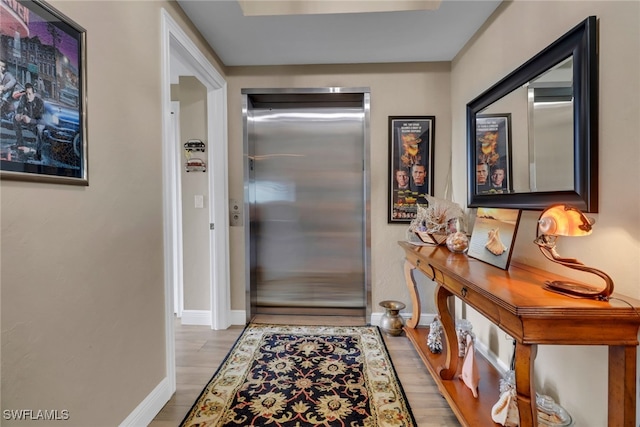 15140 Harbour Isle Dr Unit 502, Fort Myers, FL 33908 - doorway featuring elevator, baseboards, and wood finished floors