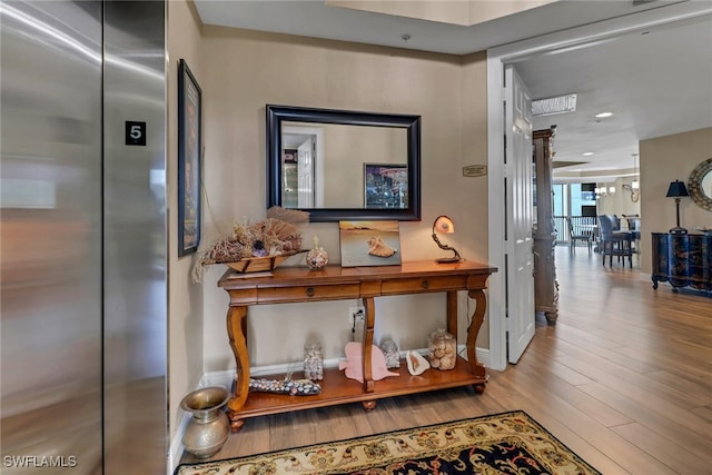 15140 Harbour Isle Dr Unit 502, Fort Myers, FL 33908 - hallway featuring elevator, wood finished floors, baseboards, and recessed lighting