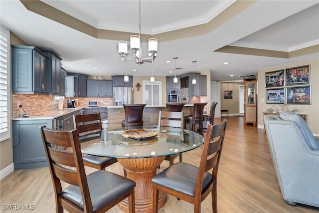 15140 Harbour Isle Dr Unit 502, Fort Myers, FL 33908 - dining room featuring a raised ceiling, a chandelier, light wood finished floors, ornamental molding, and recessed lighting
