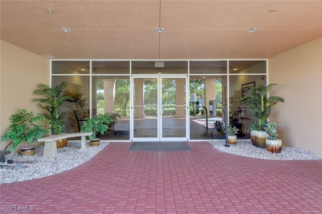 15140 Harbour Isle Dr Unit 502, Fort Myers, FL 33908 - property entrance featuring stucco siding, a patio area, and french doors