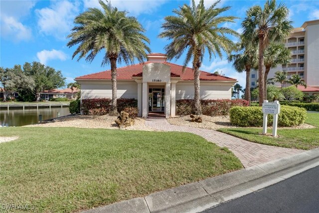 15140 Harbour Isle Dr Unit 502, Fort Myers, FL 33908 - mediterranean / spanish-style house featuring a front yard, a tiled roof, a water view, and stucco siding