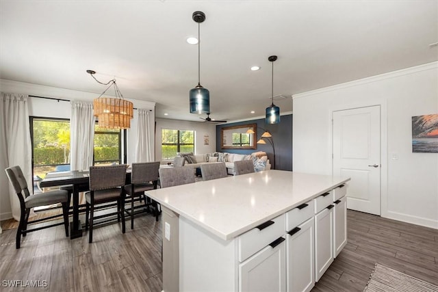 10864 Firebush Cir, North Fort Myers, FL 33917 - kitchen with recessed lighting, decorative light fixtures, a kitchen island, light countertops, and dark wood finished floors