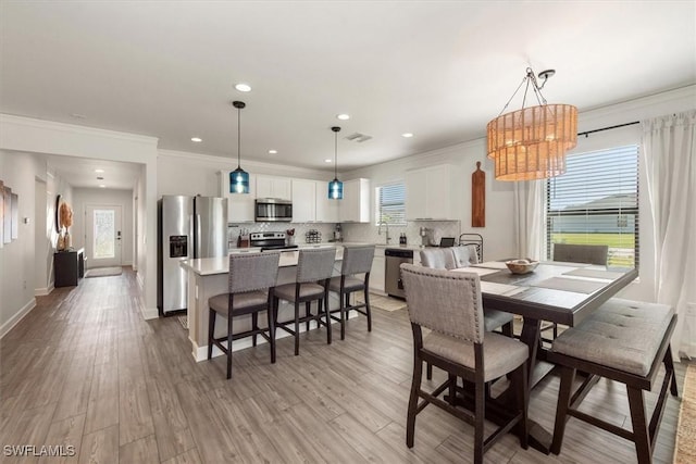 10864 Firebush Cir, North Fort Myers, FL 33917 - dining area with visible vents, a notable chandelier, light wood-style flooring, and plenty of natural light