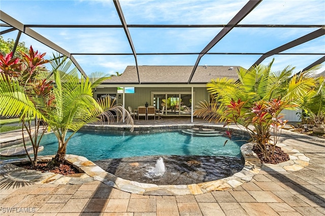 pool with a patio and glass enclosure