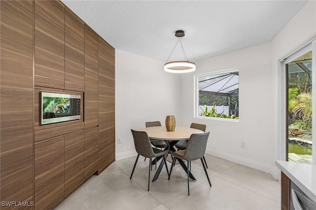dining room featuring a healthy amount of sunlight and baseboards