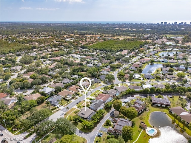 birds eye view of property featuring a water view and a residential view