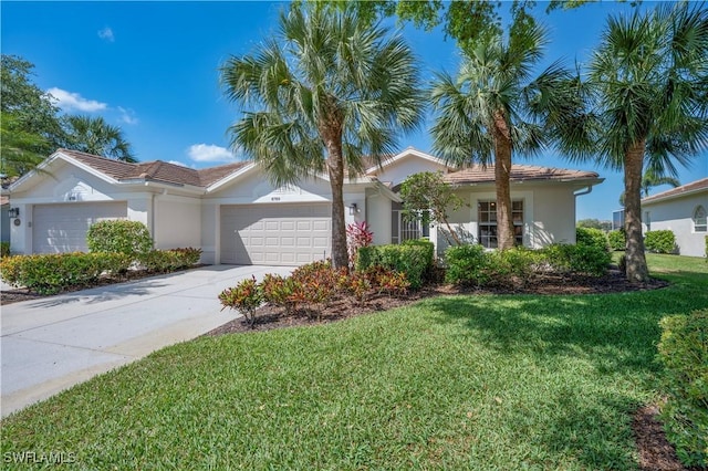 8789 Cedar Hammock Blvd Unit 61, Naples, FL 34112 - view of front of house featuring a garage, stucco siding, a front yard, and driveway