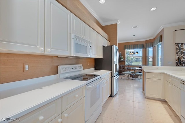 8789 Cedar Hammock Blvd Unit 61, Naples, FL 34112 - kitchen featuring white appliances, light countertops, crown molding, white cabinetry, and light tile patterned flooring