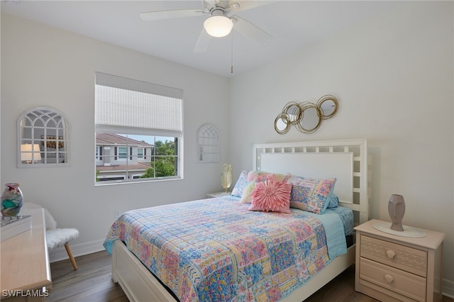bedroom featuring baseboards, ceiling fan, and dark wood-style floors