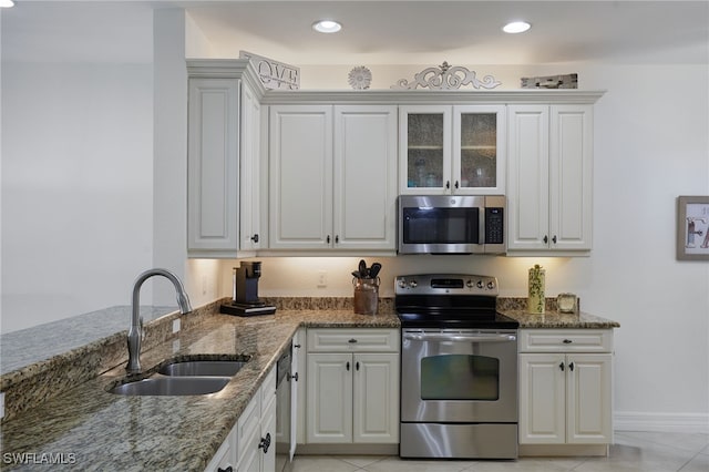 6537 Monterey Pt Unit 202, Naples, FL 34105 - kitchen featuring appliances with stainless steel finishes, stone counters, white cabinets, and recessed lighting