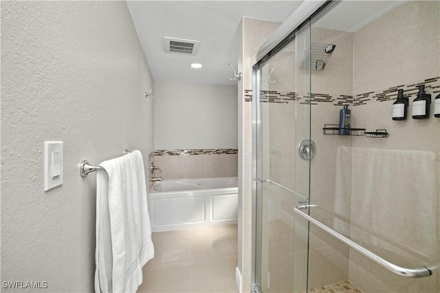828 SW 51st Ter, Cape Coral, FL 33914 - full bath featuring visible vents, a stall shower, a garden tub, and a textured wall