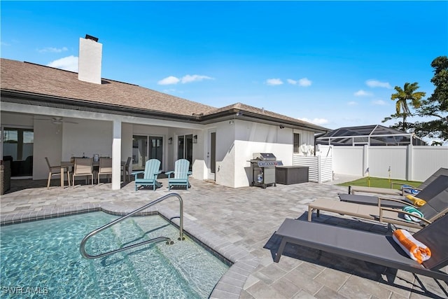 828 SW 51st Ter, Cape Coral, FL 33914 - back of property with a chimney, fence, a fenced in pool, and a patio area