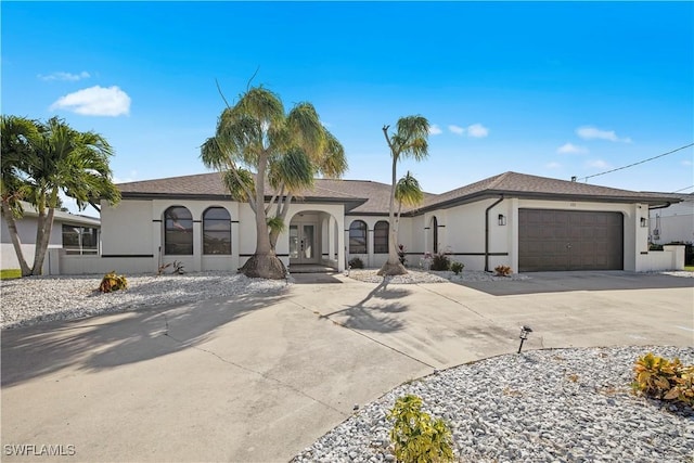 828 SW 51st Ter, Cape Coral, FL 33914 - view of front facade featuring driveway, a garage, stucco siding, and french doors