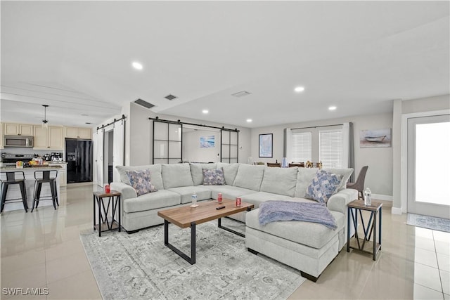 828 SW 51st Ter, Cape Coral, FL 33914 - living area featuring recessed lighting, a barn door, light tile patterned floors, visible vents, and baseboards