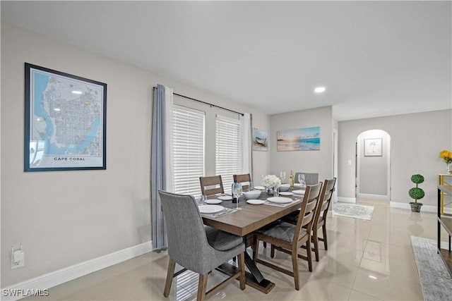 828 SW 51st Ter, Cape Coral, FL 33914 - dining area with baseboards, light tile patterned floors, arched walkways, and recessed lighting
