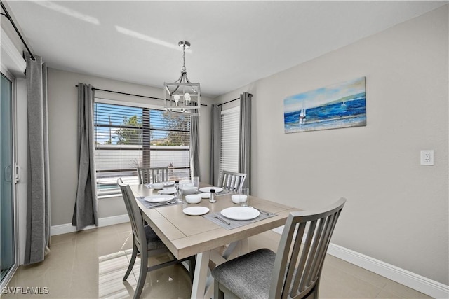 828 SW 51st Ter, Cape Coral, FL 33914 - dining room featuring light tile patterned floors, a notable chandelier, and baseboards