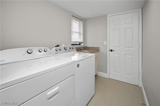 828 SW 51st Ter, Cape Coral, FL 33914 - washroom featuring a sink, cabinet space, washing machine and clothes dryer, light tile patterned floors, and baseboards