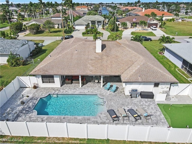 828 SW 51st Ter, Cape Coral, FL 33914 - view of swimming pool featuring a gate, a fenced backyard, and a residential view