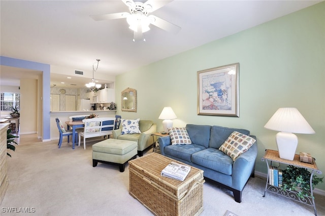 8355 Whisper Trace Way Unit K-103, Naples, FL 34114 - living area with baseboards, visible vents, ceiling fan with notable chandelier, and light colored carpet