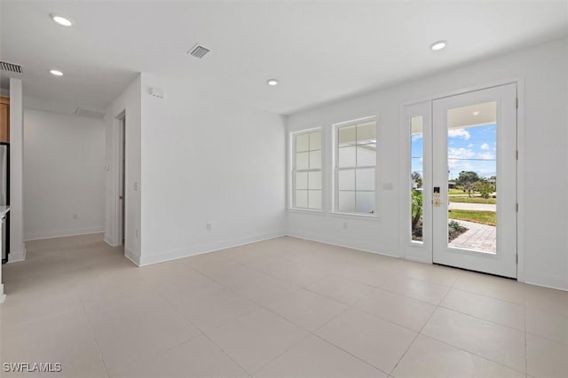 interior space with baseboards, visible vents, light tile patterned flooring, and recessed lighting