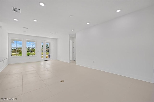 spare room with light tile patterned floors, visible vents, baseboards, recessed lighting, and french doors