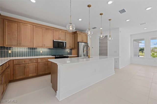 kitchen with appliances with stainless steel finishes, light countertops, brown cabinets, backsplash, and a sink