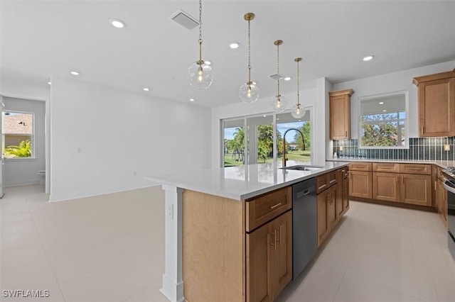 kitchen featuring stainless steel dishwasher, a sink, visible vents, light countertops, and a kitchen island with sink