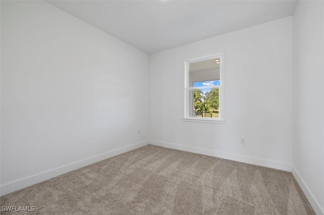 empty room with baseboards and carpet floors