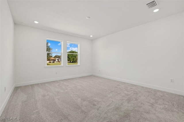 spare room with visible vents, baseboards, recessed lighting, and carpet floors
