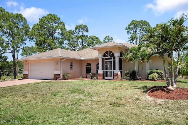 view of front of property with a front lawn, driveway, a garage, and stucco siding
