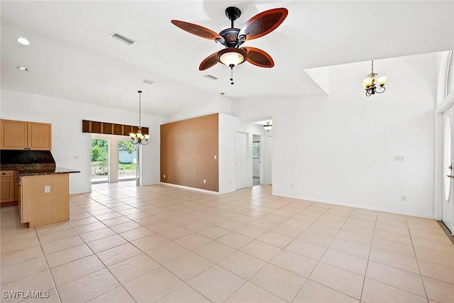 unfurnished living room with visible vents, ceiling fan with notable chandelier, light tile patterned flooring, and lofted ceiling