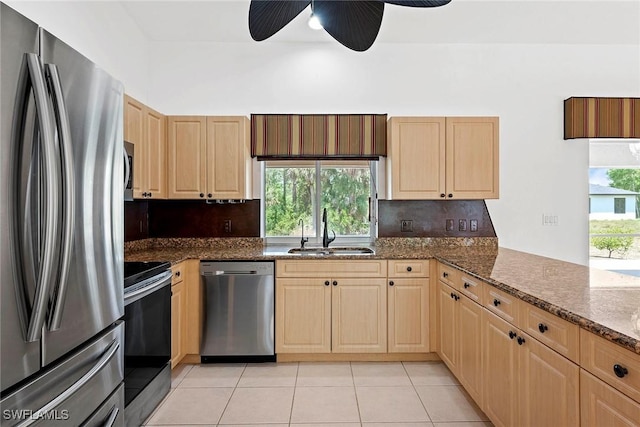 kitchen featuring light brown cabinetry, a ceiling fan, appliances with stainless steel finishes, and a sink